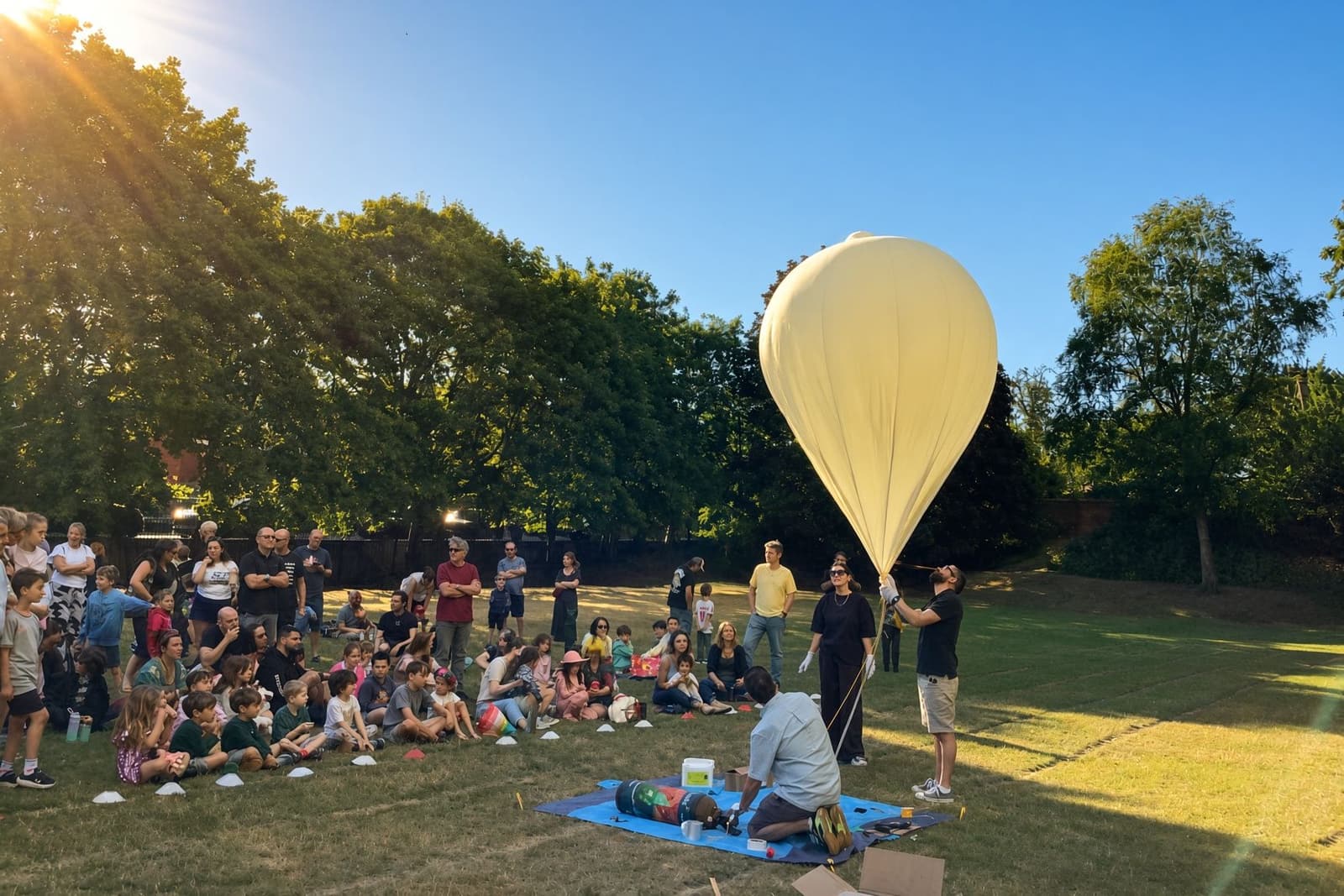 Students on a school field with a 1U payload and a helium balloon, getting ready to fly.